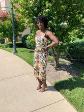 Load image into Gallery viewer, Abstract jumpsuit. Strapped with the colors yellow, green, and a base of white. Pairs perfectly with heels, flats, or sandels. Deep neckline.